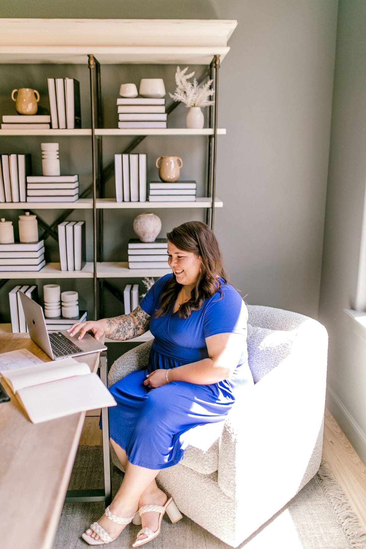 A business owner working on her laptop in a bright office